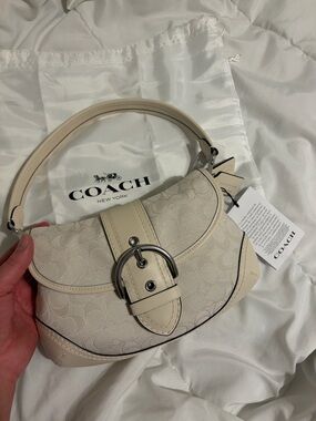 New with tags COACH Cream Signature Jacquard Leather Saddle Bag